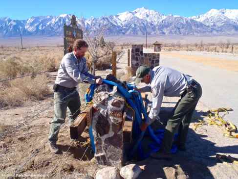 National Park Service staff begin the process of moving the California Registered Historical Landmark plaque, which was placed on the south side of the historic entrance road after it was removed from the front of the sentry post.