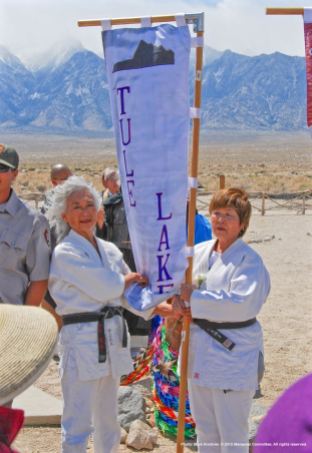 Ernie Jane Nishi (left) and Nancy Oda (right) carried the Tule Lake banner.