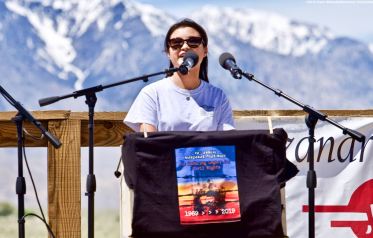 UCSD Nikkei Student Union co-President Lauren Matsumoto (right), addresses the crowd during the 50th Annual Manzanar Pilgrimage, April 27, 2019, at the Manzanar National Historic Site.